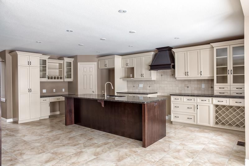 beige and brown kitchen with island with no furniture or appliances