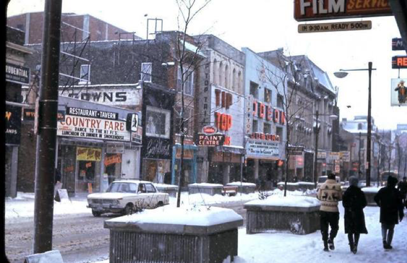 vintage city scape of downtown centre with many storefronts in the snow