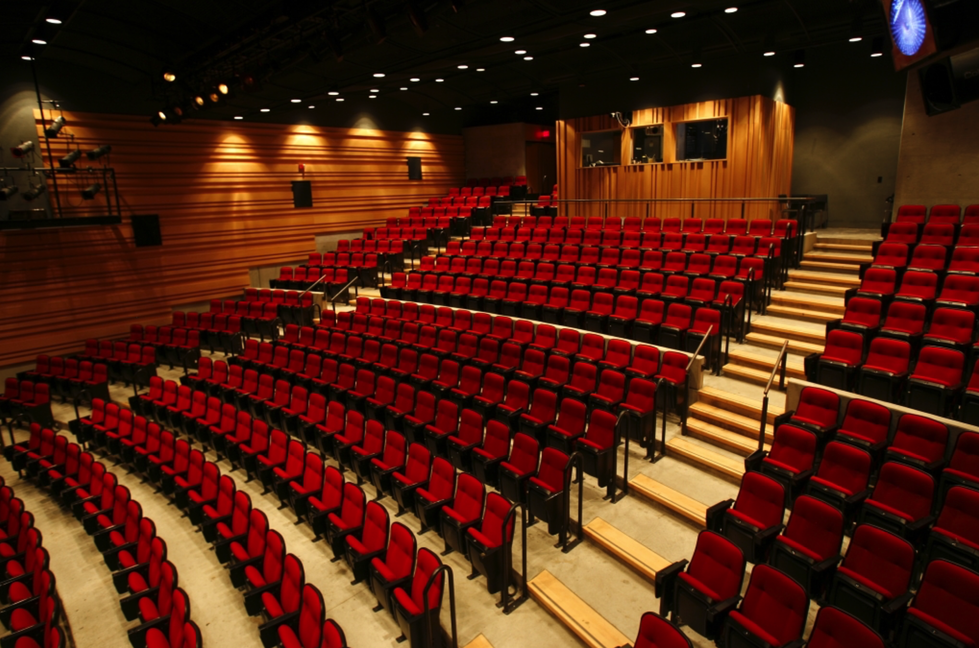 performance hall large seating area with red chairs and multiple levels